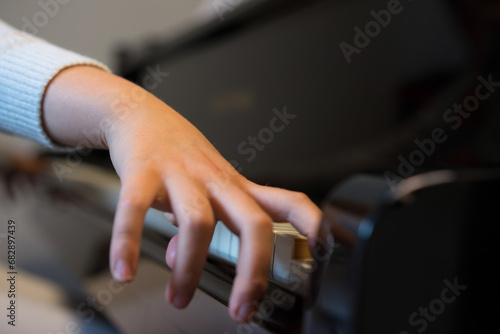 Human hands playing the keys notes and chords on a classic black piano during a pianolesson