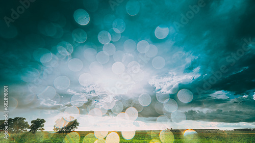 Rain Rainy Clouds Above Countryside Rural Field Landscape With Young Green Wheat Sprouts In Summer Cloudy Sunset Evening. Heavy Clouds Above Agricultural Field. Young Wheat Shoots , . photo