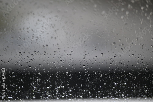 Water drops on fogged glass with a gray brightness gradient