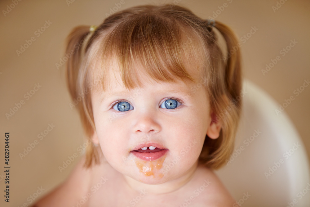 Portrait, eating and a girl baby with food on her face closeup in the home for growth or child development. Kids, breakfast and adorable little infant in a feeding chair for health, diet or nutrition Portrait, eating and a girl baby with food on her face closeup in the home for growth or child development. Kids, breakfast and adorable little infant in a feeding chair for health, diet or nutrition