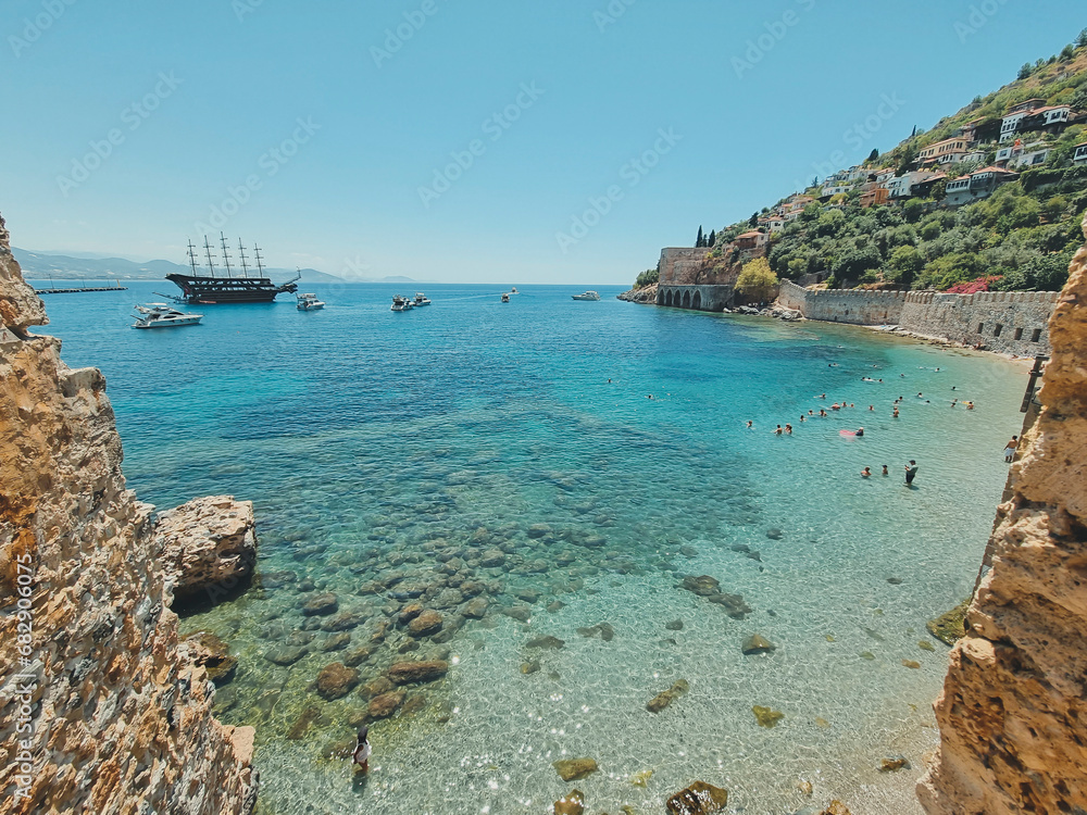 view from wall of old Alanya fortress to beautiful beach and ships, soft focus. concept of summer vacation, beach holiday