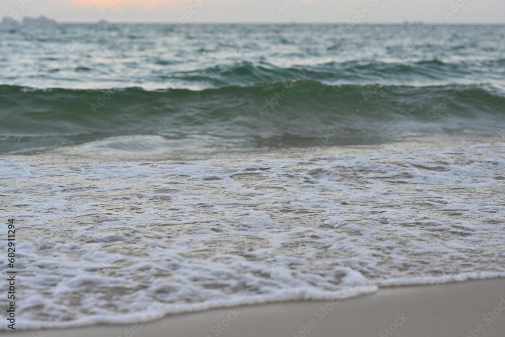 Soft foam wave of the sea on the sandy beach