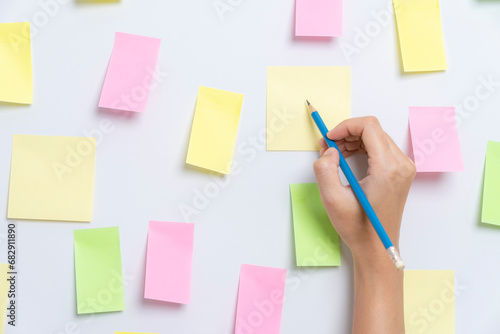 Empty sticky paper note on the wall ready to write wording