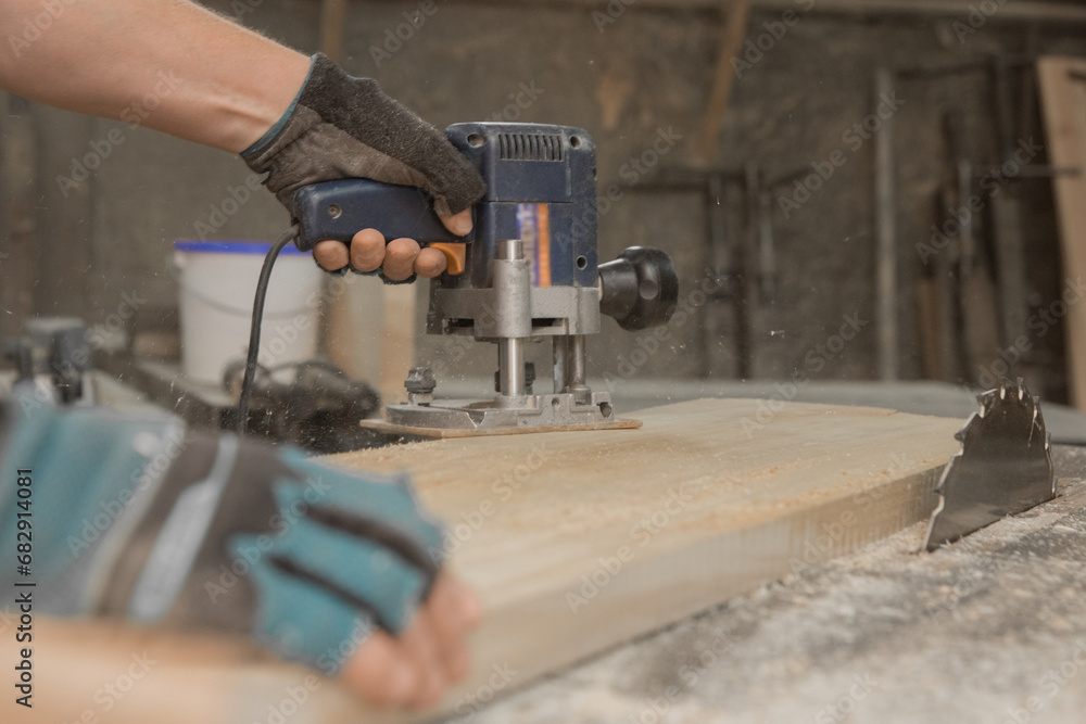 Hand male worker industry grinder tool object woodworking board industrial plank close-up Hand male worker industry grinder tool object woodworking board industrial plank close-up