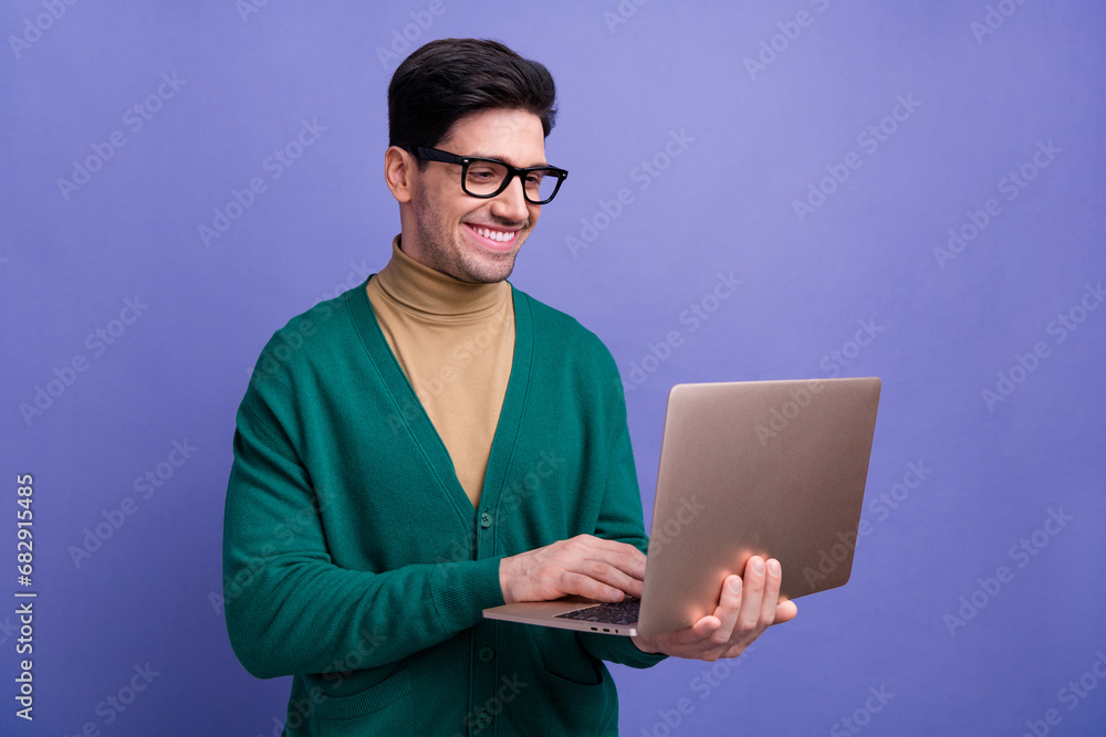 Photo of handsome man entrepreneur wear stylish clothes typing texting letter isolated on purple color background Photo of handsome man entrepreneur wear stylish clothes typing texting letter isolated on purple color background