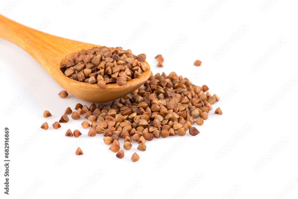 Uncooked buckwheat on wooden spoon Uncooked buckwheat on wooden spoon