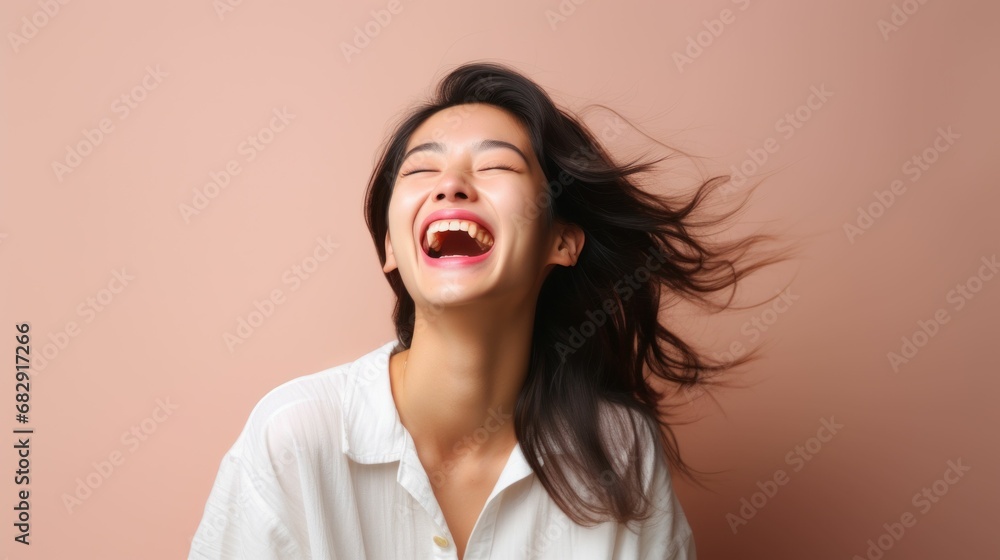 Photo, a Asian woman laughing heartily, her head thrown back in genuine amusement, the simplicity of the studio enhancing the candidness of the scene Photo, a Asian woman laughing heartily, her head thrown back in genuine amusement, the simplicity of the studio enhancing the candidness of the scene