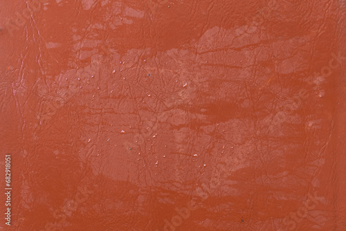 Wet water surface of orange brown leather streaks background texture stain