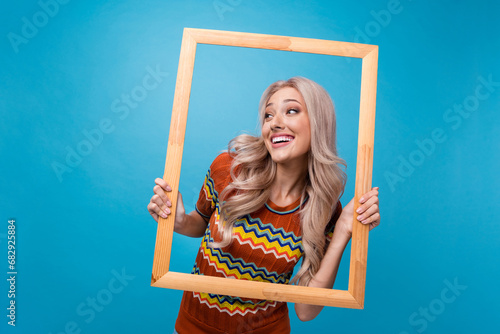 Photo of thoughtful excited lady wear print shirt shooting photo looking empty space isolated blue color background