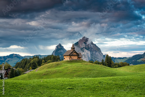 Stoos church on hill in front of Grosser Mythen mountain in summer at Schwyz, Switzerland