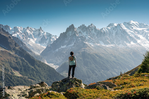 A female hiker standing with enjoying the Mont Blanc mountain range view during trail in Lac Blanc at France