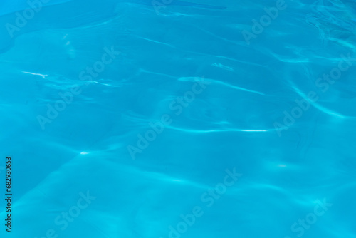 Blue clear pool water abstract nature pattern reflection wave surface transparent background