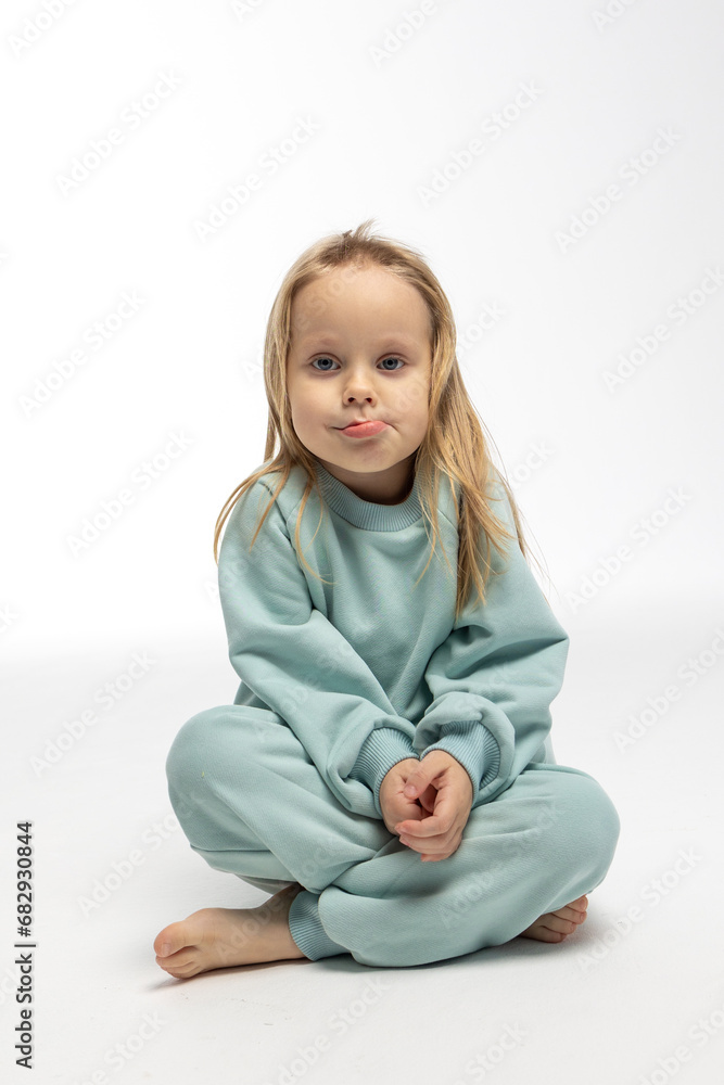 Portrait of funny little girl with funny emotions on her face. Pretty smile kid in studio on white background. High quality photo Portrait of funny little girl with funny emotions on her face. Pretty smile kid in studio on white background. High quality photo