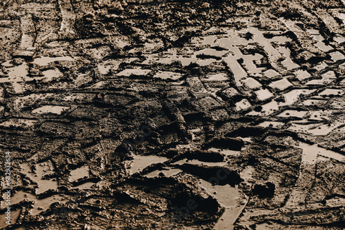 Obraz na płótnie dark muddy road background with tire traces, dirty ground w salonie