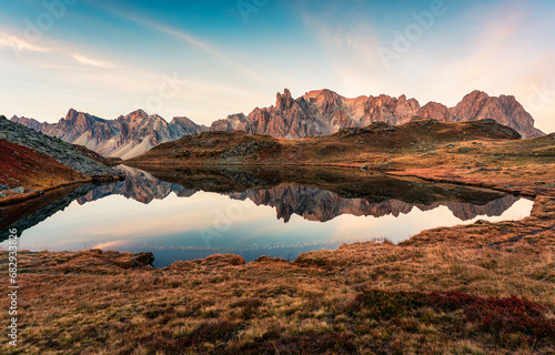 Sunrise over Lac Long with Massif des cerces reflection on the lake in Claree valley at French Alps  France