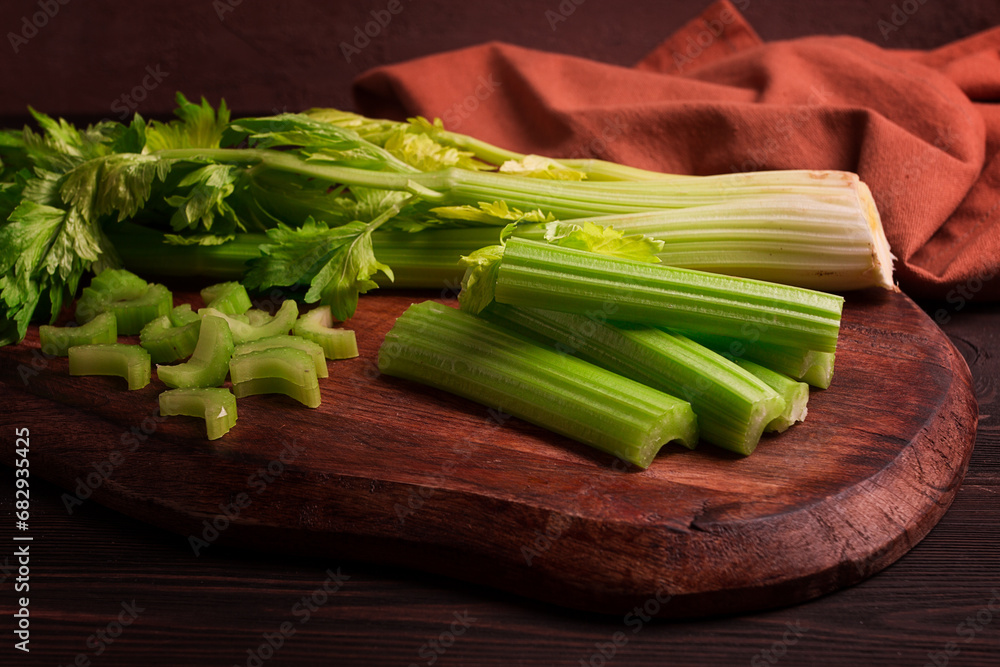 fresh bunch of celery, top view, no people, on a dark background, fresh bunch of celery, top view, no people, on a dark background,
