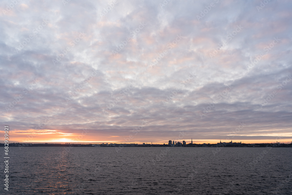 Dawn over the city of Tallinn as seen from the sea from the shore of Paljassaare.