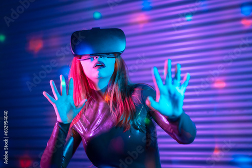 Shocked woman during an interactive game with VR goggles