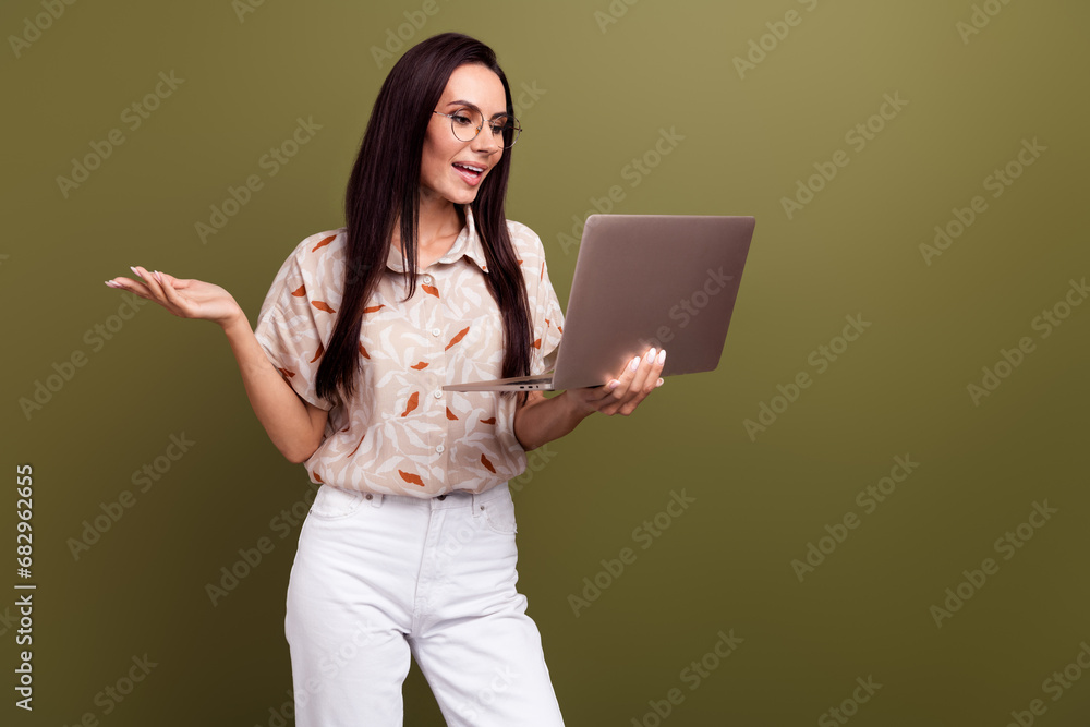 Photo of young business lady has a conversation in online with investors telling current situation isolated on khaki color background Photo of young business lady has a conversation in online with investors telling current situation isolated on khaki color background