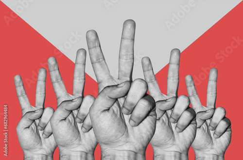 Digital collage with male hand with victory sign photo