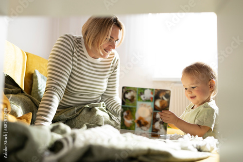 Cozy mother and toddler reading time at home photo