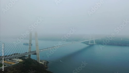 Bosphorus Istanbul, covered by dense fog. Aerial view of Yavuz Sultan Selim Bridge in mist. Widest suspension bridge, YSS Bridge has a main span of 1408m long and towers 330m high
 photo