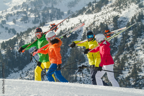 Group of Skiers Carrying Equipment in Swiss Alps photo