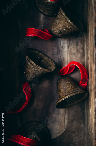 Vintage bells with red ribbons on wooden background