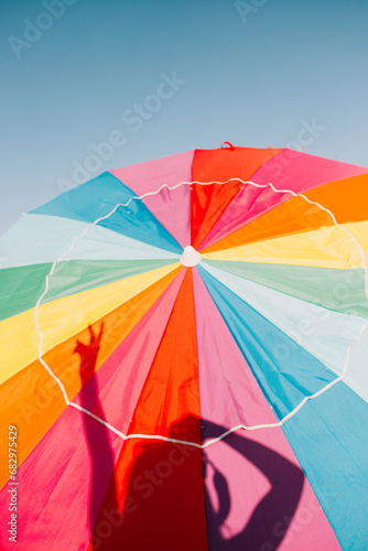 Colorful beach umbrella under the clear blue sky photo