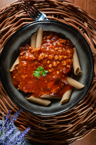 Wholegrain penne pasta with bolognese sauce.