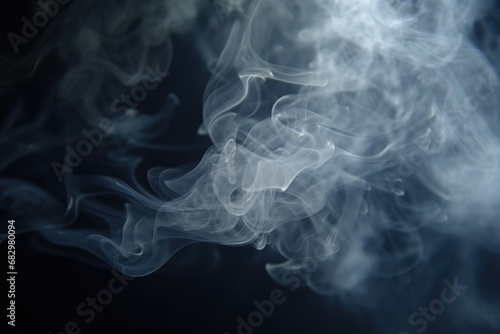 Smoke captured in a close-up shot on a black background. This image can be used to depict mystery, pollution, fire, or even as a background for text or graphic overlays.