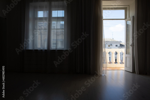 Interior of an empty dark room with windows