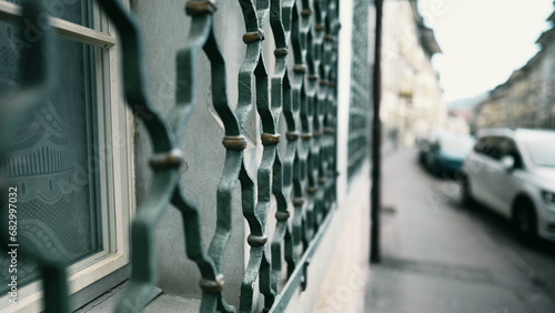Vászonkép Protective metal window fence patterns to defend from intruders in building faca