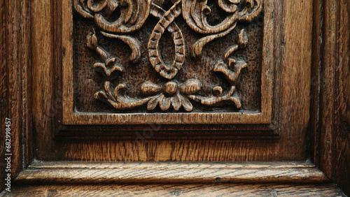 Timeless Craftsmanship - Engraved Adornments on Antique Wooden Door of Traditional Building © Marco