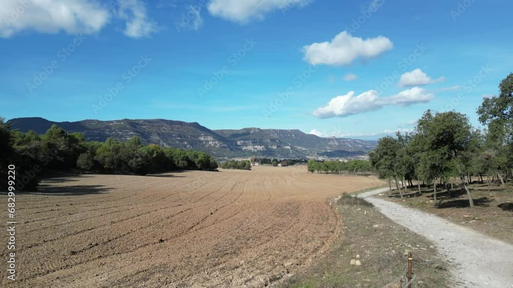 Aerial view of a rural field surrounded by mountains Aerial view of a rural field surrounded by mountains