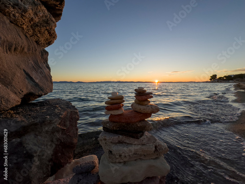 Canvas Print wonderful sunset time with sea cliffs and zen stones texture