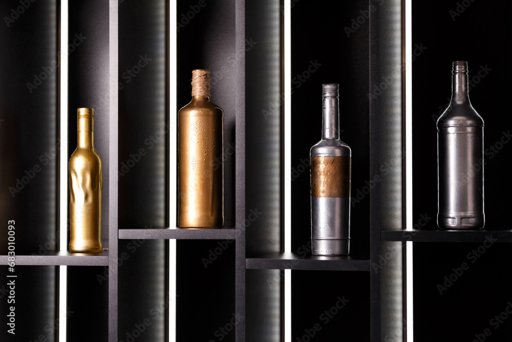 Bottles of alcohol stand on illuminated bar shelves. Decor of a restaurant, bar. Bottles of alcohol stand on illuminated bar shelves. Decor of a restaurant, bar.