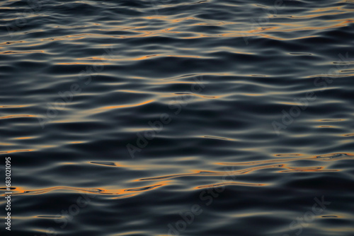 Rough and wavy sea surface with sun reflection on the top of the waves