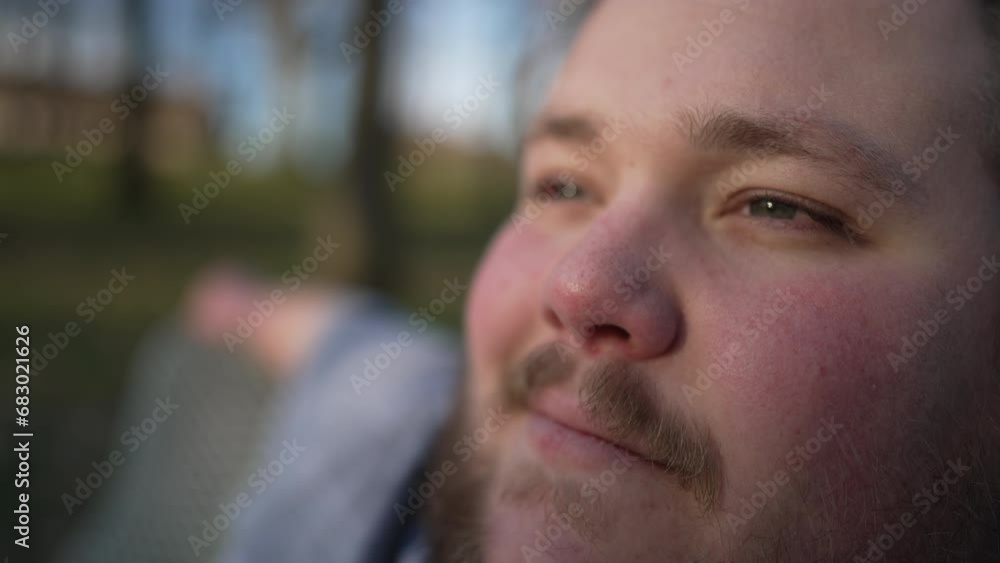 Happy young man close up face smiling outdoors relaxing Happy young man close up face smiling outdoors relaxing