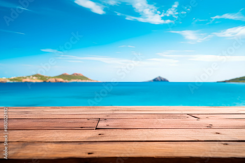 A wooden table set against the backdrop of the sea  an island  and the blue sky.Empty space for text. Bright image.