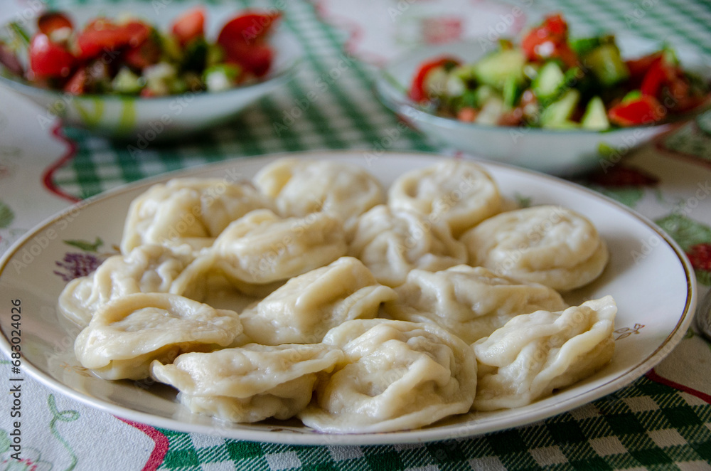 Traditional Russian food - pelmeni. On a plate. Sa Traditional Russian food - pelmeni. On a plate. Sa
