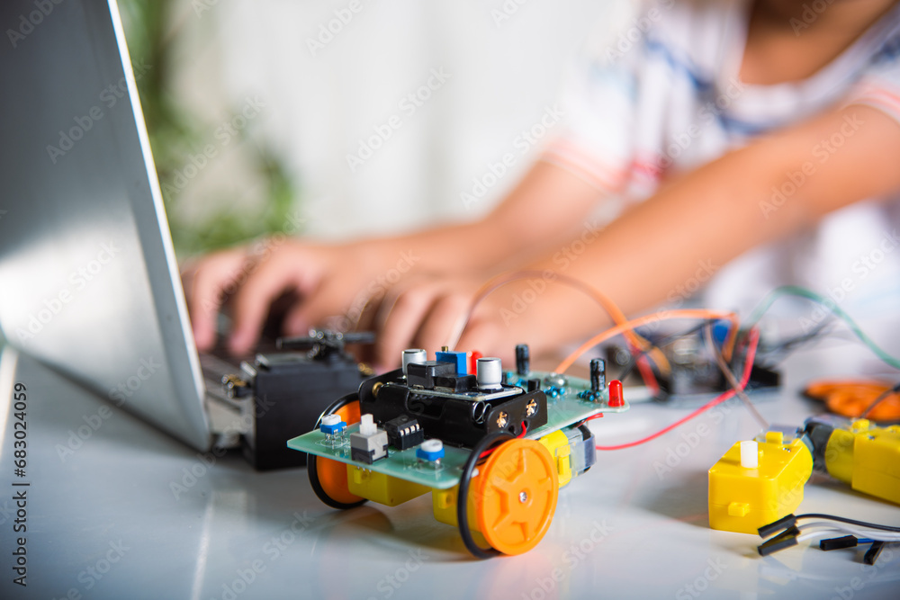 Klittle Kid Coding Asian kid boy learns coding and programming with laptop for Arduino ...