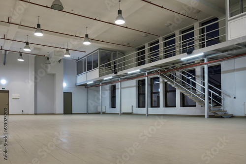 Obraz na plátně Interior of a large illuminated industrial space with mezzanine