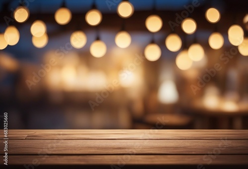 Wooden table top on blur beach bar background with bokeh lights