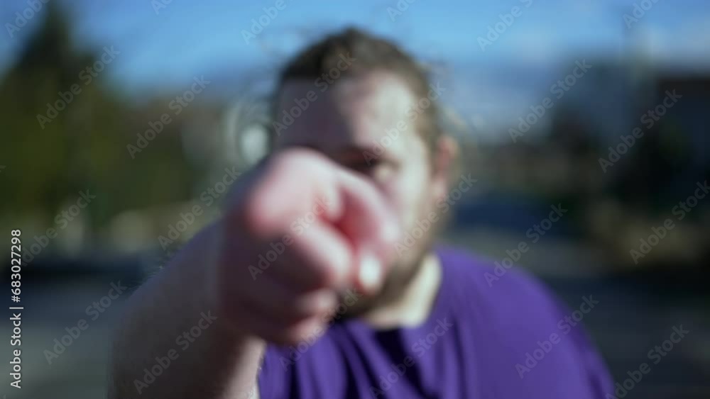 One angry judgemental man pointing finger at camera standing outside. One chubby Person points hand accusing. POV accusation concept One angry judgemental man pointing finger at camera standing outside. One chubby Person points hand accusing. POV accusation concept