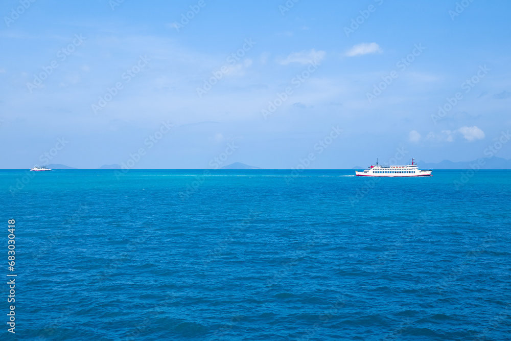 A cargo ferry sails across the blue sea on the Gulf of Thailand