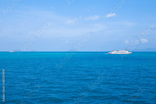 A cargo ferry sails across the blue sea on the Gulf of Thailand