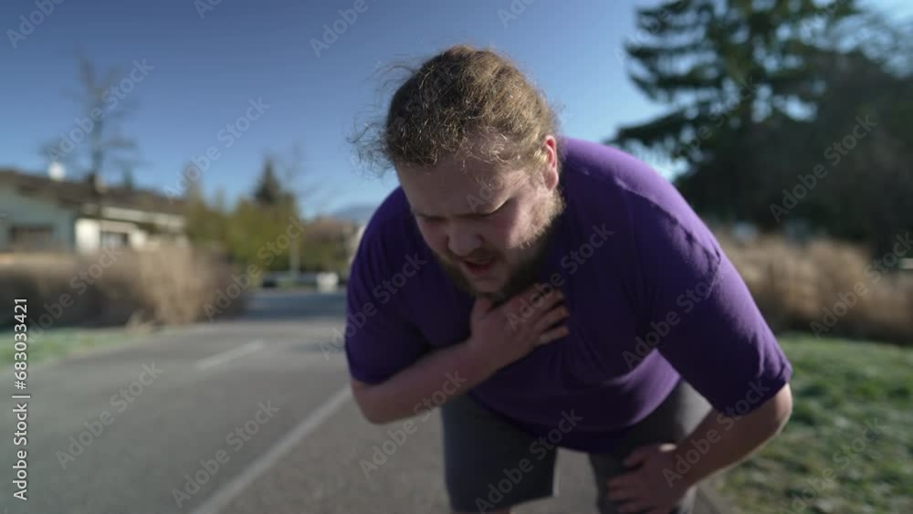 One fat man gasping for air outside after exercise. Overweight person having chest pain suffering respiratory problems unable to breath One fat man gasping for air outside after exercise. Overweight person having chest pain suffering respiratory problems unable to breath