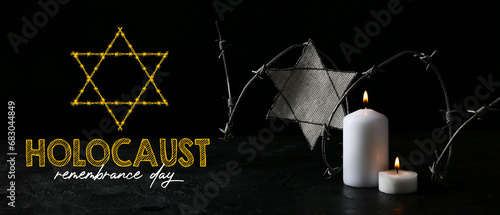 David star, barbed wire and burning candles on dark background. International Holocaust Remembrance Day photo