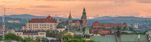 Wawel castle during colorful sunset with snowy Tatra mountains in the background, Krakow, Poland photo